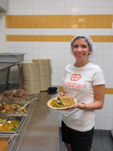 Breanne at the Drop- In Centre serving a Mealshare Dinner. 