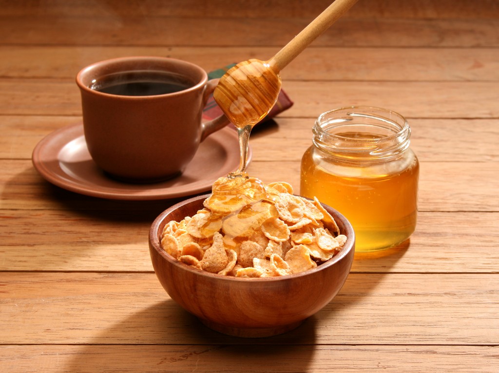Breakfast scene. Honey pouring into a cereal bowl. © Julián Rovagnati ID 3400454 | Dreamstime Stock Photos