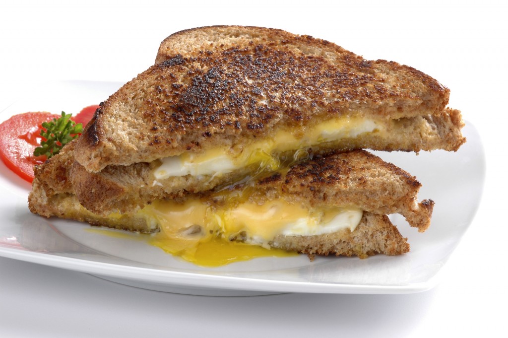 Messy fried egg sandwich with cheese on a white background.© William Berry ID 2532127 | Dreamstime Stock Photos